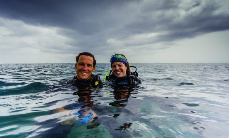 Photo of Drs. Chelsea Harm-Tuohy ’10,11 and Evan Tuohy ‘09, Under the Deep Blue Sea