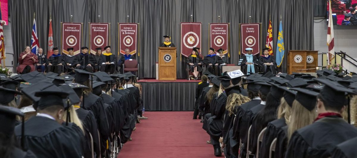 A stage during commencement with seated graduates on either side