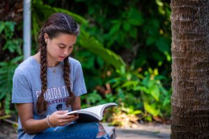 Female student reading in Patterson Botanical Garden