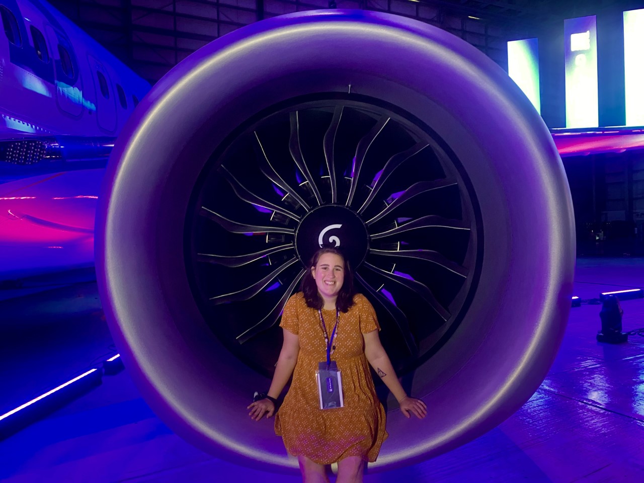 Alumna Taylor Rains sitting in an engine of United Airlines’ Boeing 737 MAX jet.