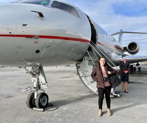 Taylor Rains '17 standing with VistaJet’s Global 5000 private jet in Montreal, Canada, before flying on it to New Jersey.
