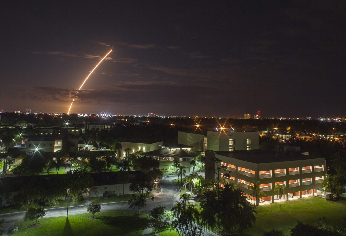 Aerial view of the Florida Tech campus at night during the Atlas V Navy launch.